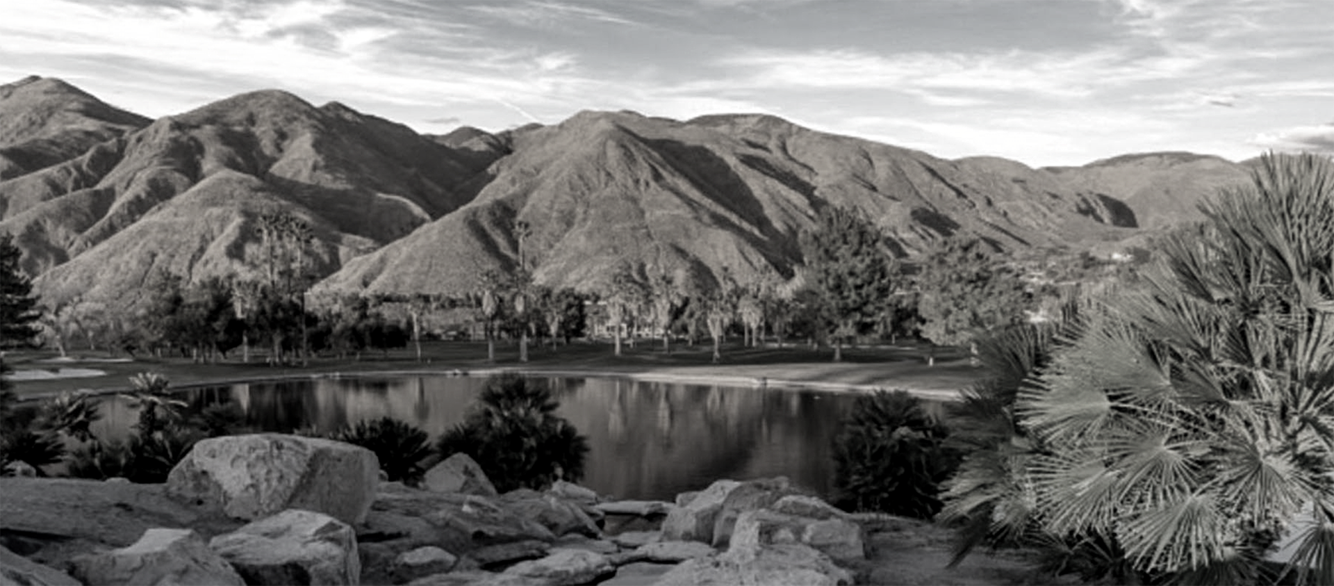 mountain range with lake in front of it